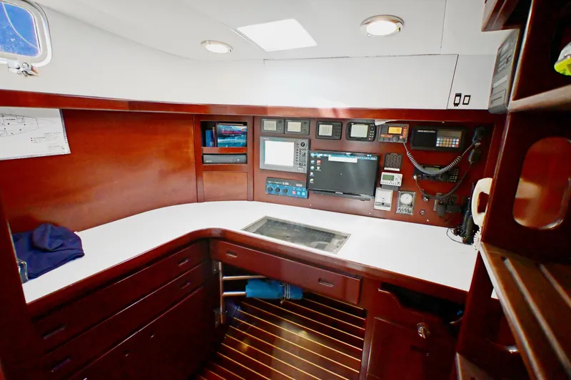 Slide: The Image of Navigation station of a 1968 Abeking & Rasmussen Tripp 74 yacht, featuring control panels and equipment. - 18