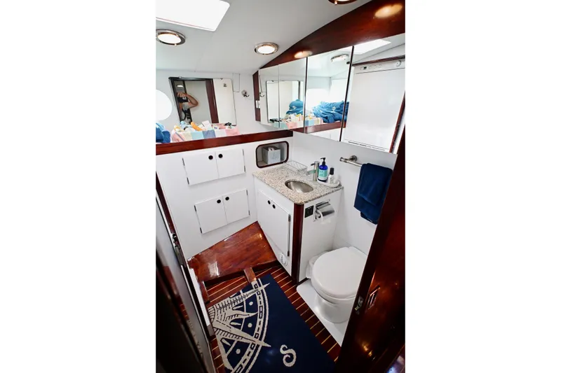 Slide: The Image of Luxurious yacht bathroom with modern fixtures, wooden accents, and nautical-themed decor. Abeking & Rasmussen Tripp 74, 1968. - 22