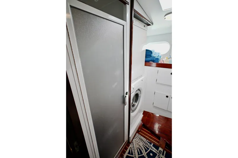 Slide: The Image of Laundry area on 1968 Abeking & Rasmussen Tripp 74 yacht with washing machine and storage. - 23