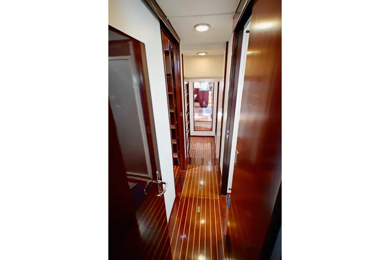 Slide: The Image of Narrow wooden hallway inside a 1968 Abeking & Rasmussen Tripp 74 yacht. - 24