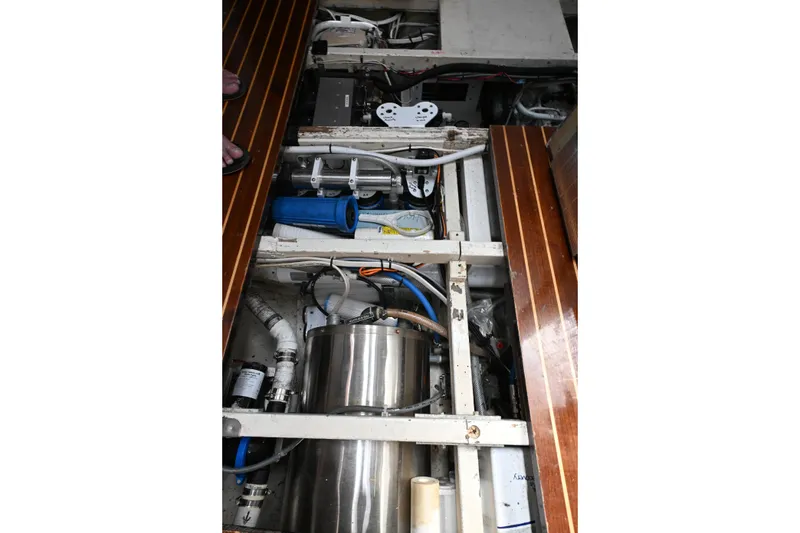 Slide: The Image of Engine room of a 1968 Abeking & Rasmussen Tripp 74 yacht, showcasing mechanical components. - 26
