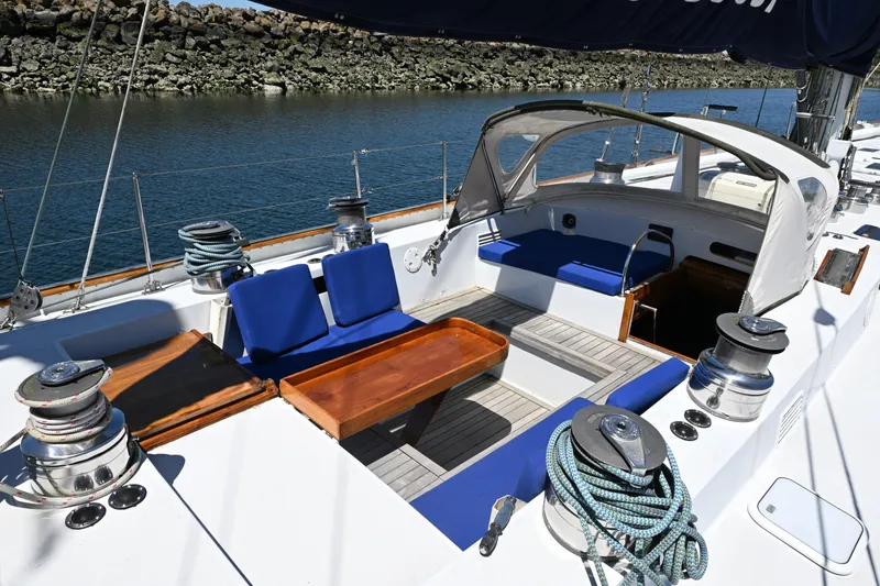 Slide: The Image of Cockpit of 1968 Abeking & Rasmussen Tripp 74 yacht with blue seating and wooden table. - 28