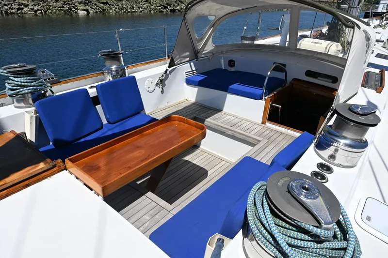 Slide: The Image of Cockpit of 1968 Abeking & Rasmussen Tripp 74 yacht with blue seating and wooden table. - 32