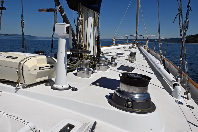 Slide: The Image of Deck view of 1968 Abeking & Rasmussen Tripp 74 yacht, featuring winches and ocean backdrop. - 39