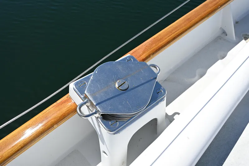 Slide: The Image of Deck detail of a 1968 Abeking & Rasmussen Tripp 74 yacht, featuring polished metal hardware. - 48