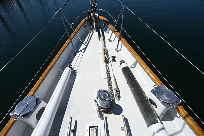 Slide: The Image of Bow of 1968 Abeking & Rasmussen Tripp 74 yacht with anchor chain and wooden railings. - 50