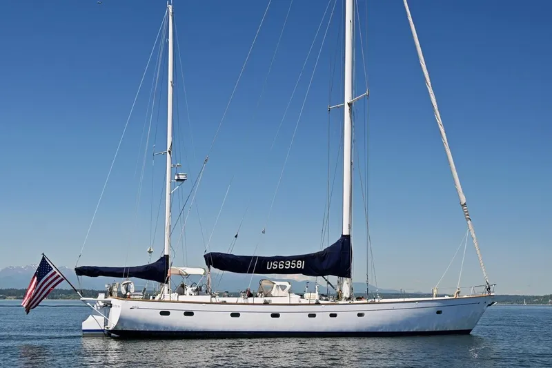 Slide: The Image of Sailing yacht Abeking & Rasmussen Tripp 74, 1968 model, on calm waters with clear blue sky. - 53