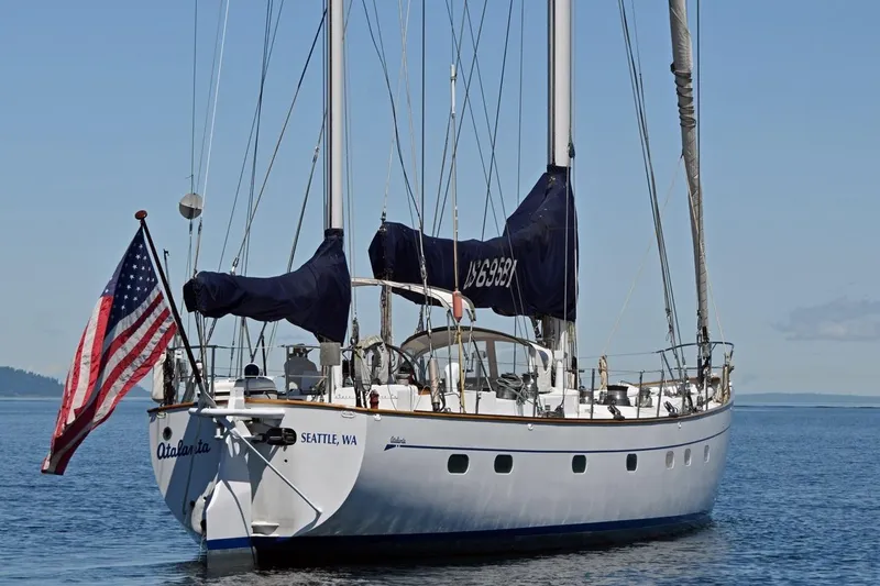 Slide: The Image of Sailing yacht "Atalanta," Abeking & Rasmussen Tripp 74, 1968, on calm waters with American flag. - 54
