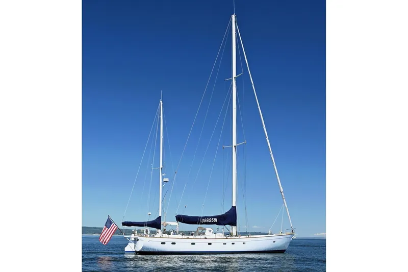 Slide: The Image of Sailing yacht Abeking & Rasmussen Tripp 74, 1968 model, on calm waters under clear blue sky. - 58