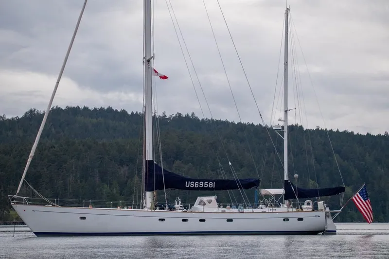 Slide: The Image of Sailing yacht Abeking & Rasmussen Tripp 74, 1968, on calm water with forested background. - 62