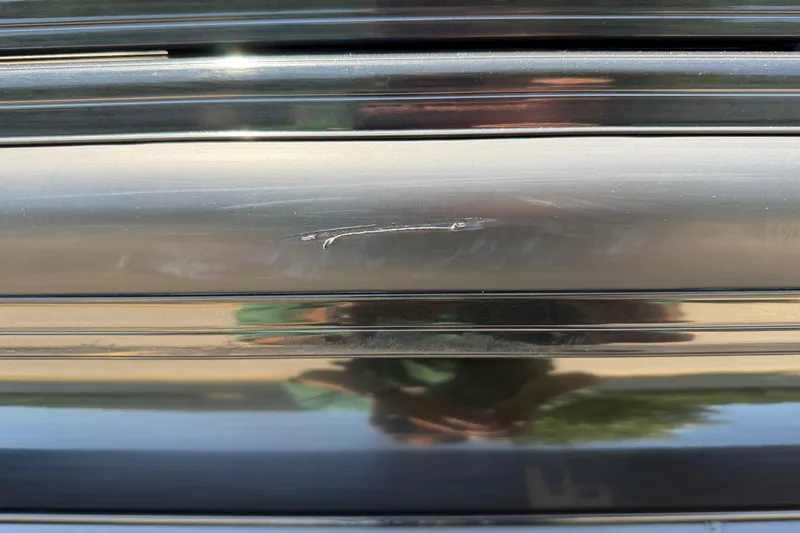 Slide: The Image of Scratch on 2024 Regency R250DL3 black surface, reflecting surroundings. - 10