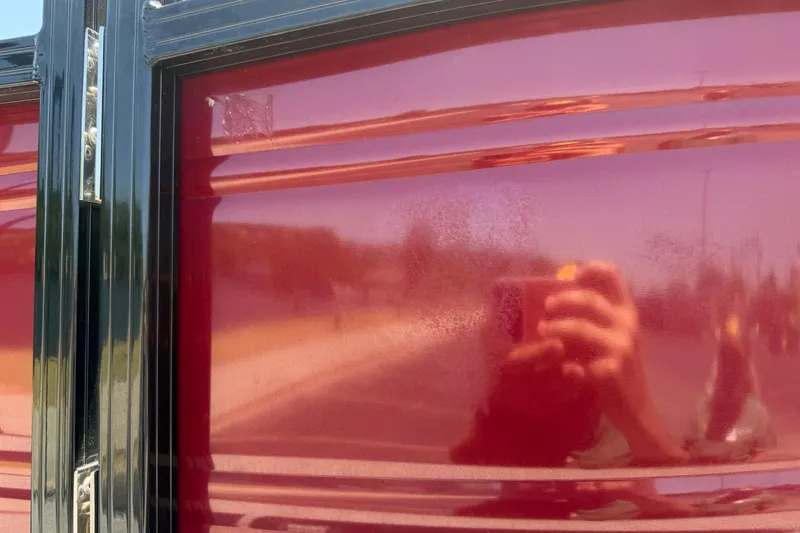 Slide: The Image of Reflection on glossy red surface of 2024 Regency R250DL3 vehicle. - 12