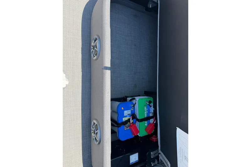Slide: The Image of 2024 Regency R250DL3 boat battery compartment with Interstate batteries and speaker. - 15