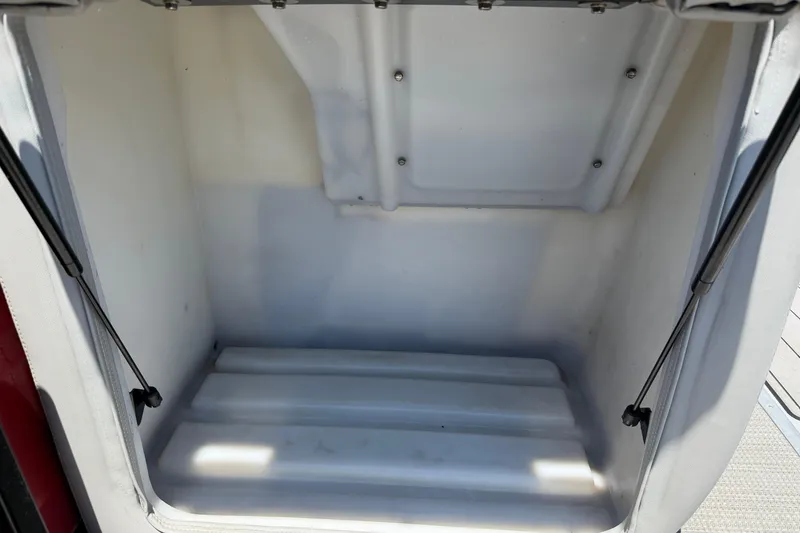 Slide: The Image of Empty storage compartment of 2024 Regency R250DL3 boat, featuring a clean, white interior. - 16