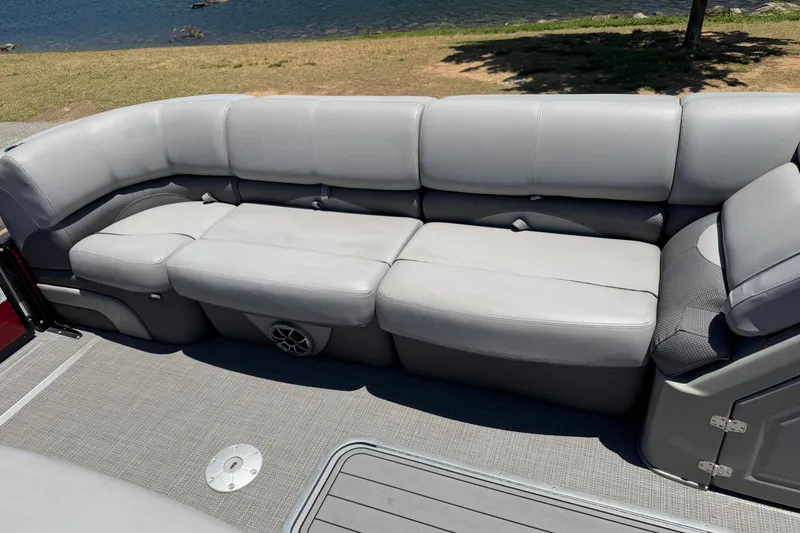 Slide: The Image of Luxurious seating on 2024 Regency R250DL3 pontoon boat by the water. - 17
