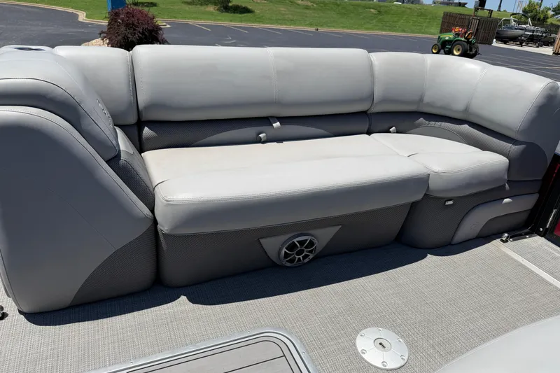 Slide: The Image of 2024 Regency R250DL3 boat interior with gray cushioned seating and speaker system. - 18