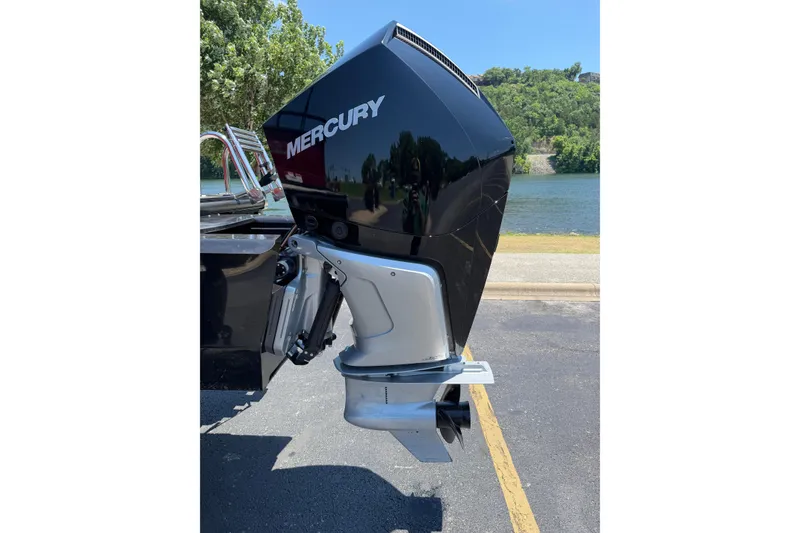 Slide: The Image of 2024 Regency R250DL3 boat with Mercury outboard motor by a scenic lake. - 19