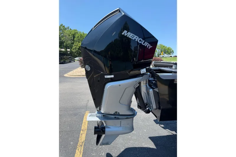 Slide: The Image of 2024 Regency R250DL3 boat with Mercury outboard motor in a sunny outdoor setting. - 20
