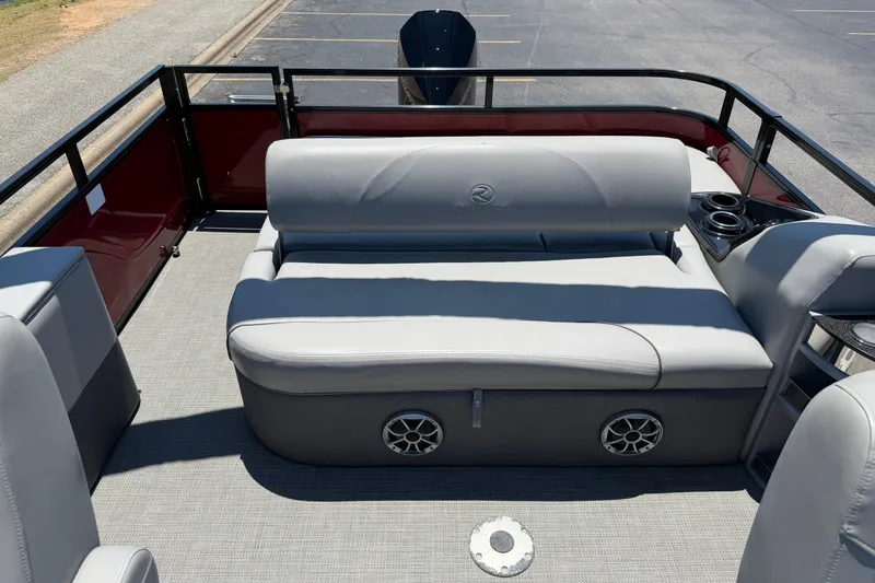Slide: The Image of 2024 Regency R250DL3 pontoon boat interior with gray seating and cup holders. - 21