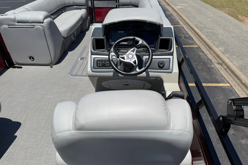 Slide: The Image of 2024 Regency R250DL3 boat interior with steering console and plush seating. - 23
