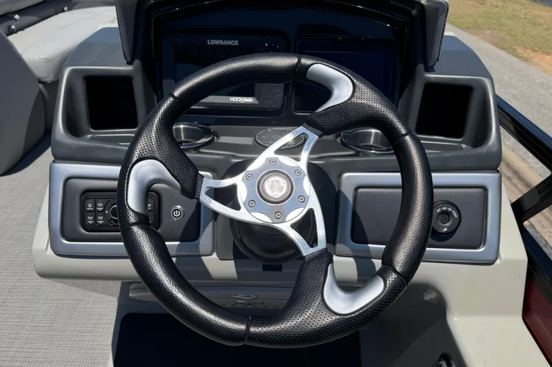 Slide: The Image of Steering wheel of 2024 Regency R250DL3 boat with modern dashboard controls. - 24