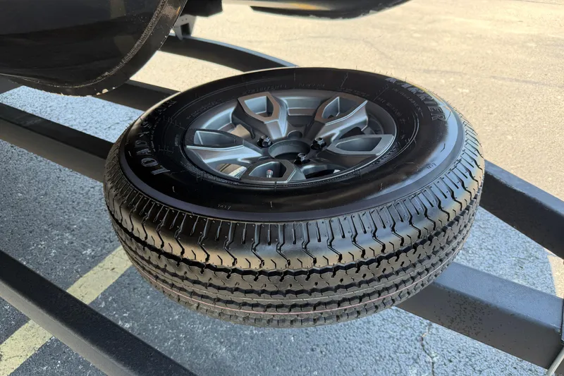 Slide: The Image of 2024 Regency R250DL3 spare tire mounted on a trailer, showcasing tread and alloy wheel design. - 29