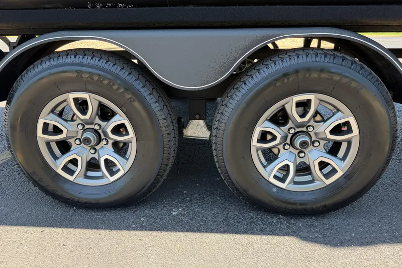 Slide: The Image of 2024 Regency R250DL3 trailer wheels with Karrier Load Star tires on asphalt. - 30