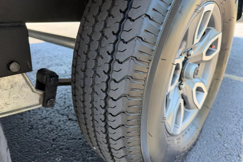 Slide: The Image of Close-up of a 2024 Regency R250DL3 tire and wheel on asphalt. - 31