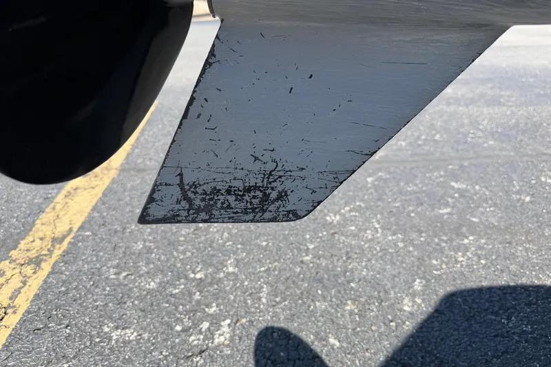 Slide: The Image of 2024 Regency R250DL3 boat propeller with visible wear and scratches on asphalt background. - 33