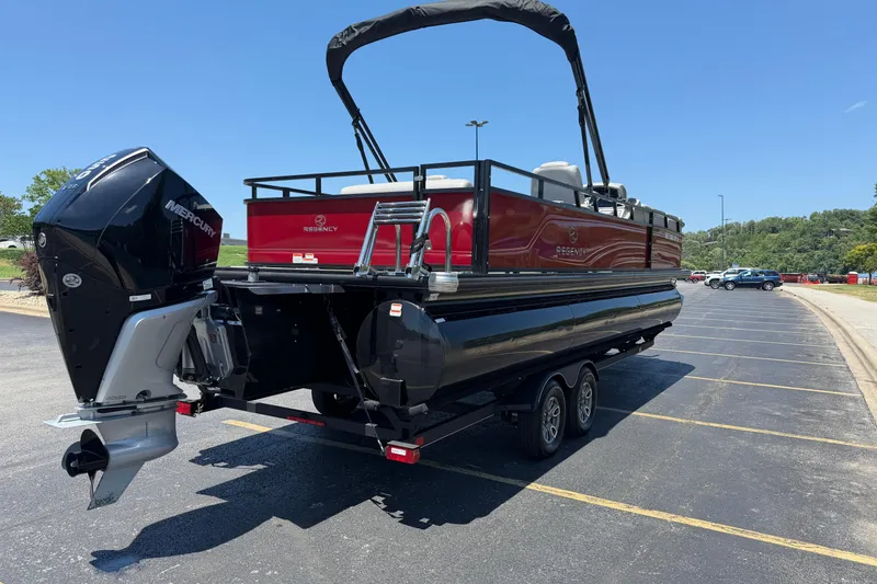 Slide: The Image of 2024 Regency R250DL3 pontoon boat with Mercury outboard engine on a trailer. - 4