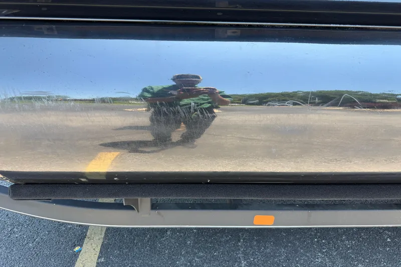 Slide: The Image of Reflection on 2024 Regency R250DL3 boat's polished surface in a parking lot. - 9