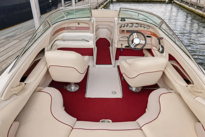 Slide: The Image of Interior of a 1997 Sea Ray 230 Signature boat with red and cream seating. - 20