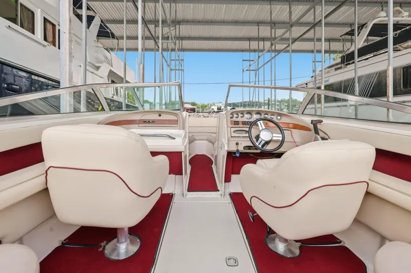 Slide: The Image of Interior of a 1997 Sea Ray 230 Signature boat with red and white seating. - 23