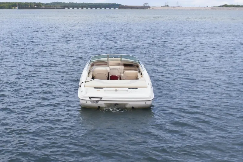 Slide: The Image of 1997 Sea Ray 230 Signature boat on calm water under blue sky. - 4