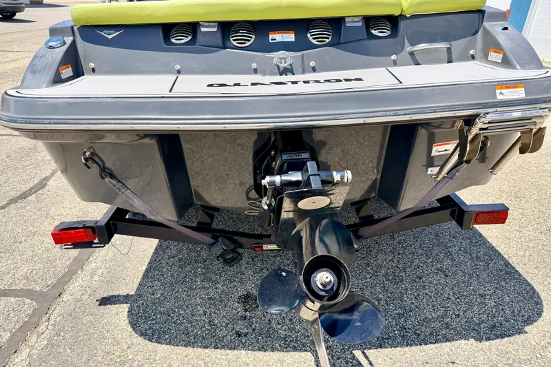 Slide: The Image of Rear view of 2018 Glastron GT 185 boat on trailer, showing propeller and hull details. - 15