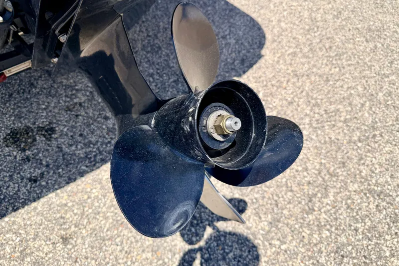Slide: The Image of Close-up of a 2018 Glastron GT 185 boat propeller on asphalt surface. - 17