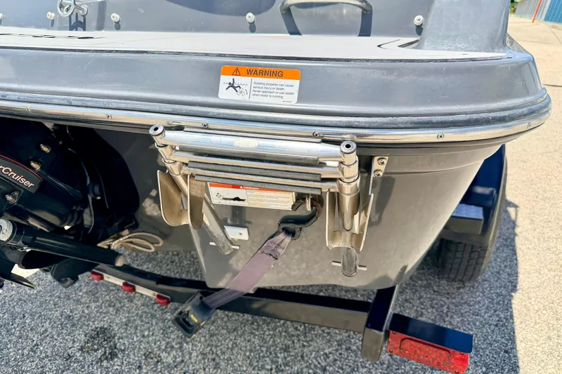 Slide: The Image of Rear view of a 2018 Glastron GT 185 boat with ladder and warning label. - 20