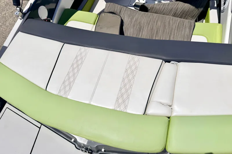 Slide: The Image of 2018 Glastron GT 185 boat interior with green and white seating. - 21