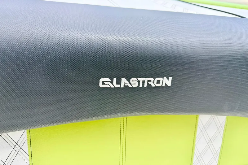 Slide: The Image of Glastron GT 185 2018 boat seat with logo, featuring green and white upholstery. - 24