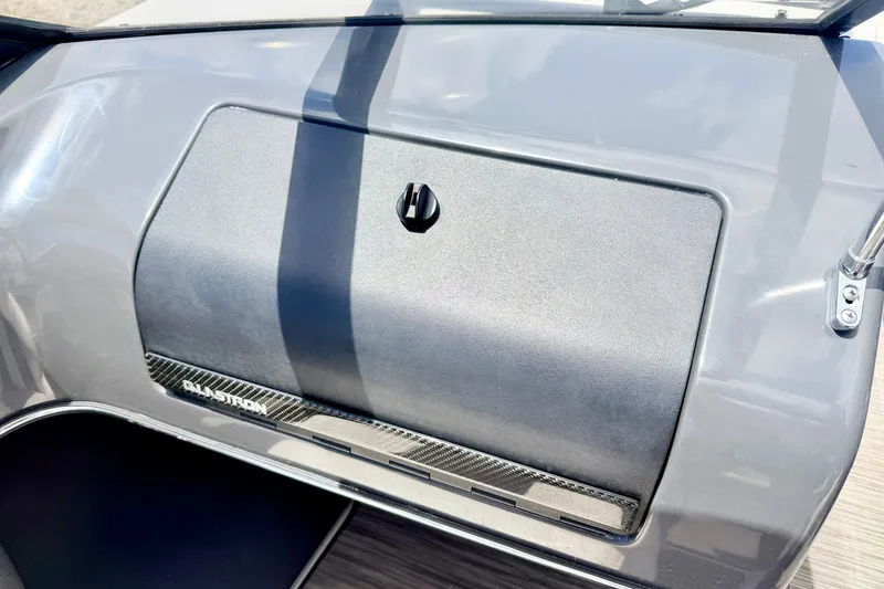 Slide: The Image of Dashboard of a 2018 Glastron GT 185 boat with storage compartment. - 28