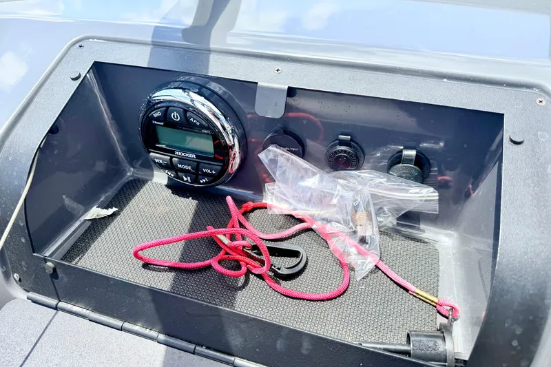 Slide: The Image of Dashboard of 2018 Glastron GT 185 boat with audio controls and red cord. - 29