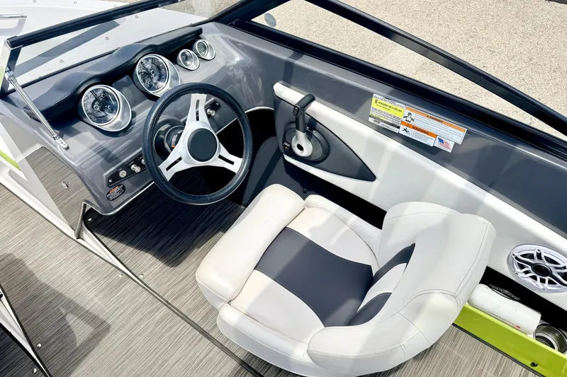 Slide: The Image of 2018 Glastron GT 185 boat interior with steering wheel and dashboard controls. - 31