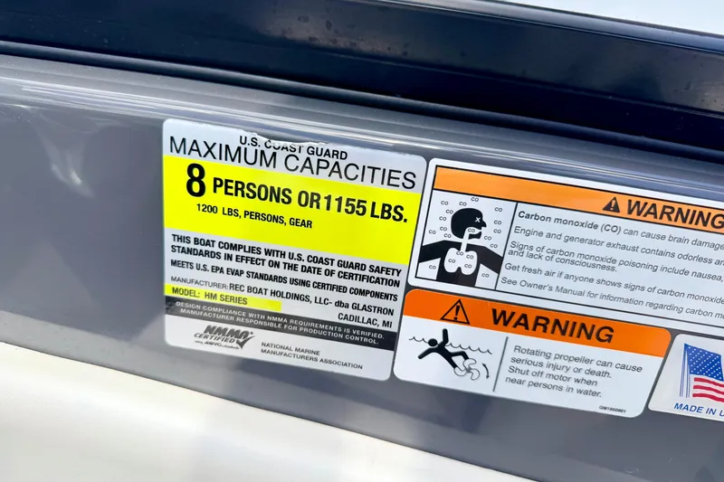Slide: The Image of 2018 Glastron GT 185 capacity label, warning for 8 persons or 1155 lbs, safety instructions. - 32
