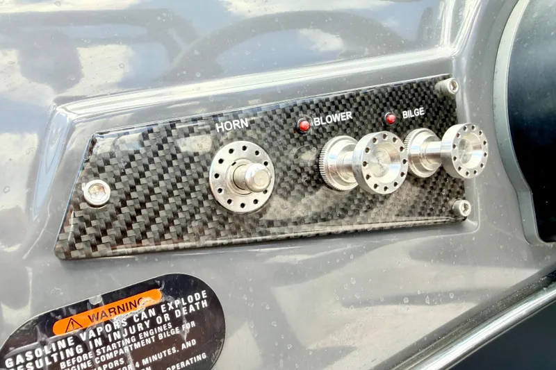 Slide: The Image of Control panel of a 2018 Glastron GT 185 boat with horn, blower, and bilge switches. - 36