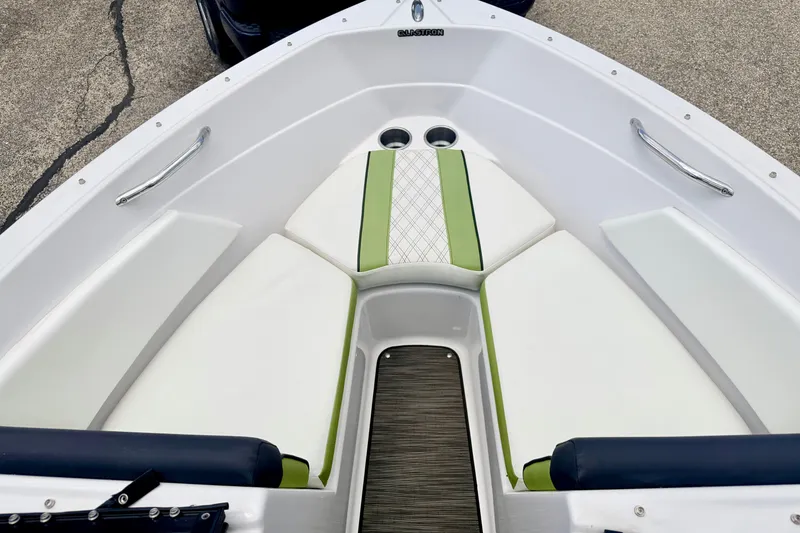 Slide: The Image of 2018 Glastron GT 185 boat interior with white and green seating. - 40
