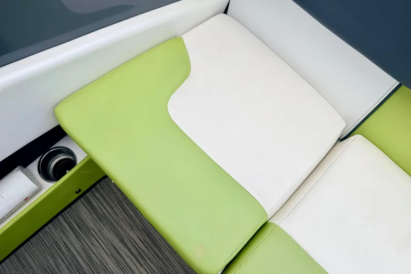 Slide: The Image of Green and white seating on 2018 Glastron GT 185 boat interior. - 41