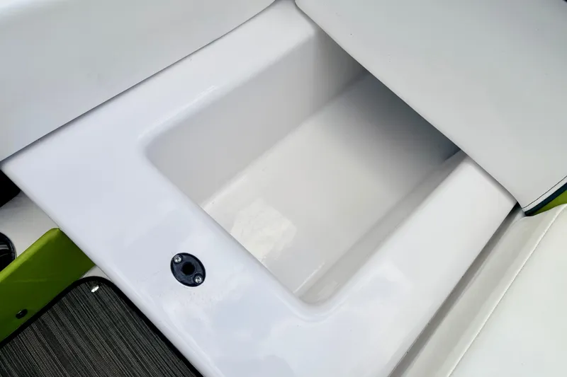 Slide: The Image of Storage compartment on a 2018 Glastron GT 185 boat, featuring sleek white design. - 42