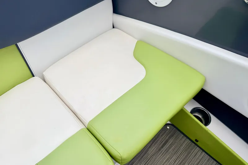 Slide: The Image of Green and white seating on 2018 Glastron GT 185 boat interior. - 43