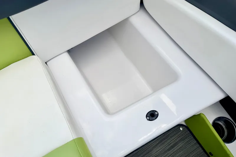 Slide: The Image of 2018 Glastron GT 185 boat interior storage compartment with white and green seating. - 44