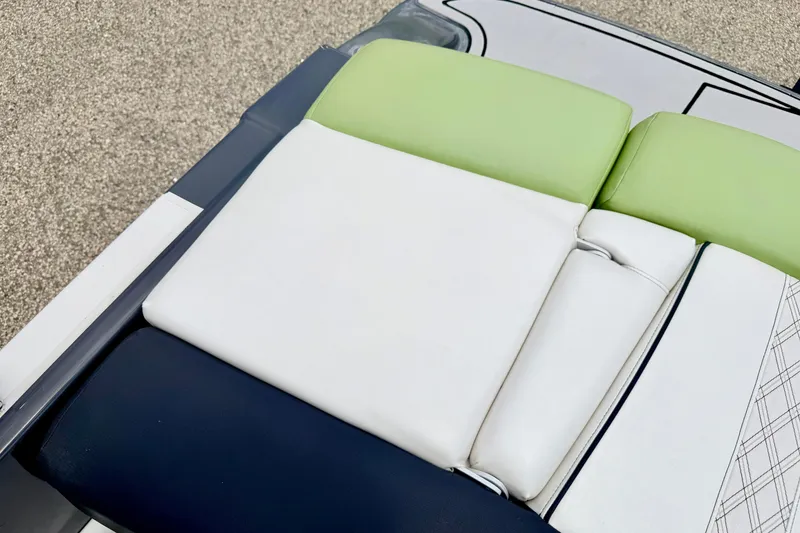 Slide: The Image of 2018 Glastron GT 185 boat seat with green, white, and navy upholstery. - 47